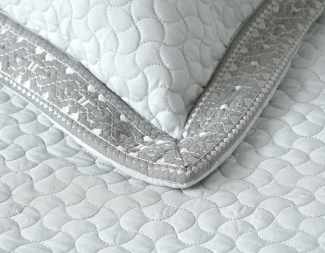 Luxury quilted embroidered bedding set by The Gharnish, five-piece bedcover ensemble with detailed stitching and elegant design.
