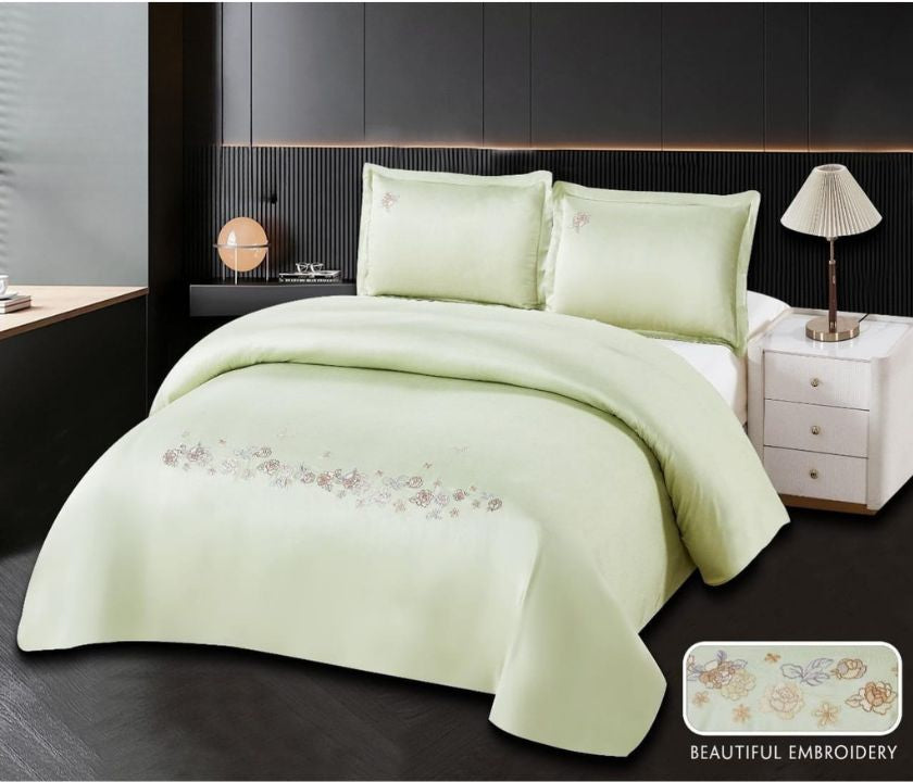100% cotton embroidery bedding set by The Gharnish, featuring a detailed floral design on a soft, white bedspread with matching pillowcases.