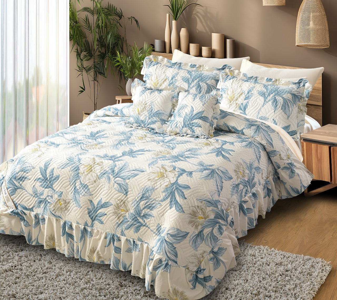 Floral bedding set on a bed in a bedroom with plants and decor.