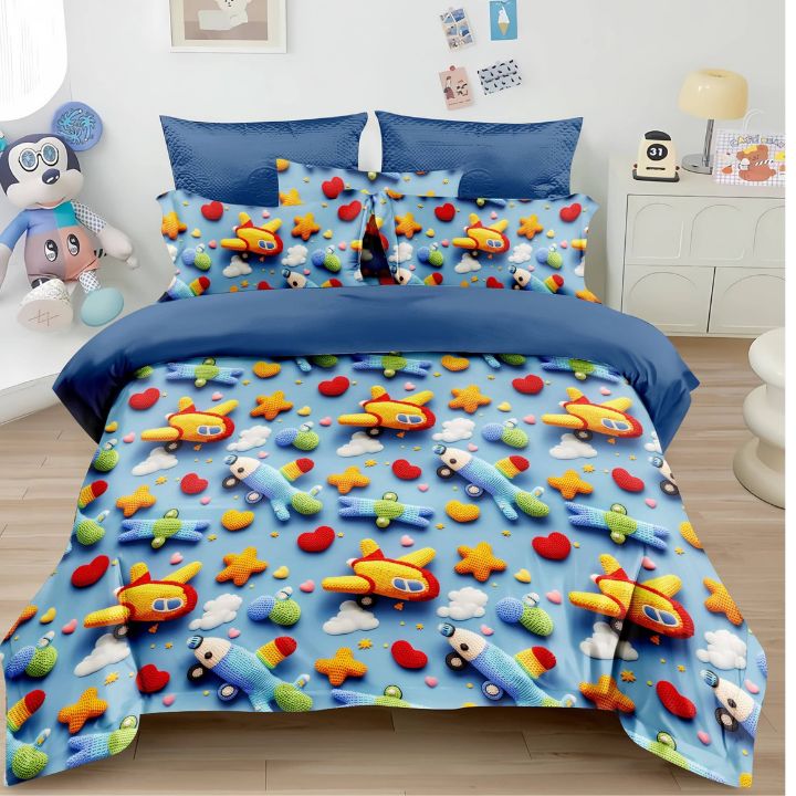 Children's bedding set with airplane and star patterns on a bed in a room.