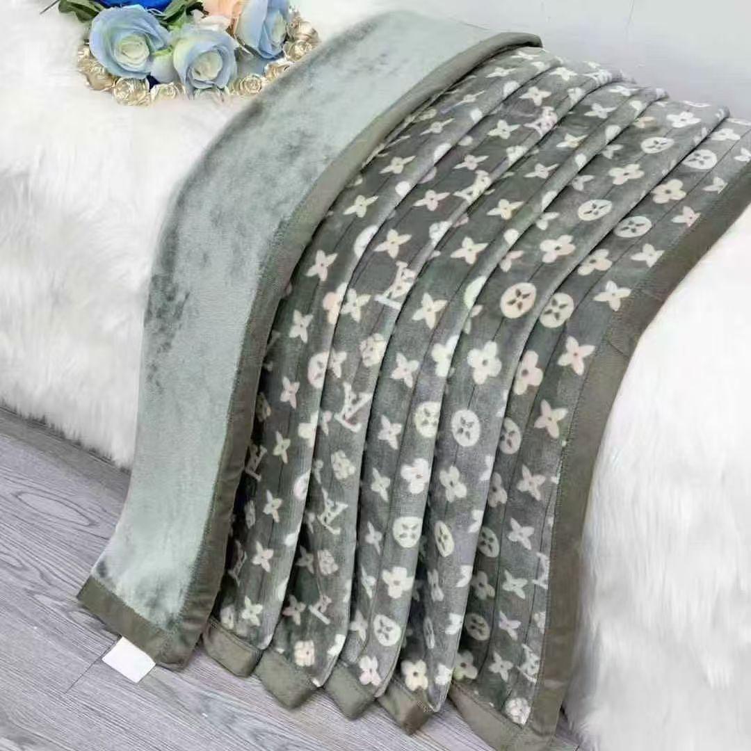 Gray blanket with floral pattern on a white surface