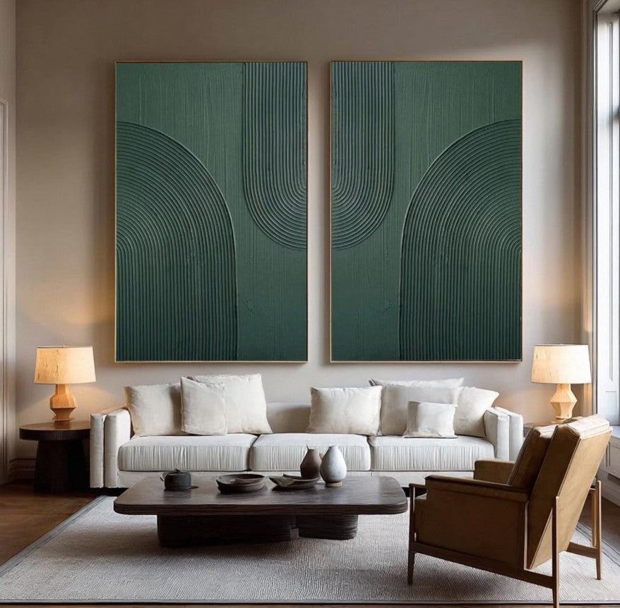 Modern living room with a white sofa, wooden coffee table, and two abstract green paintings on the wall.