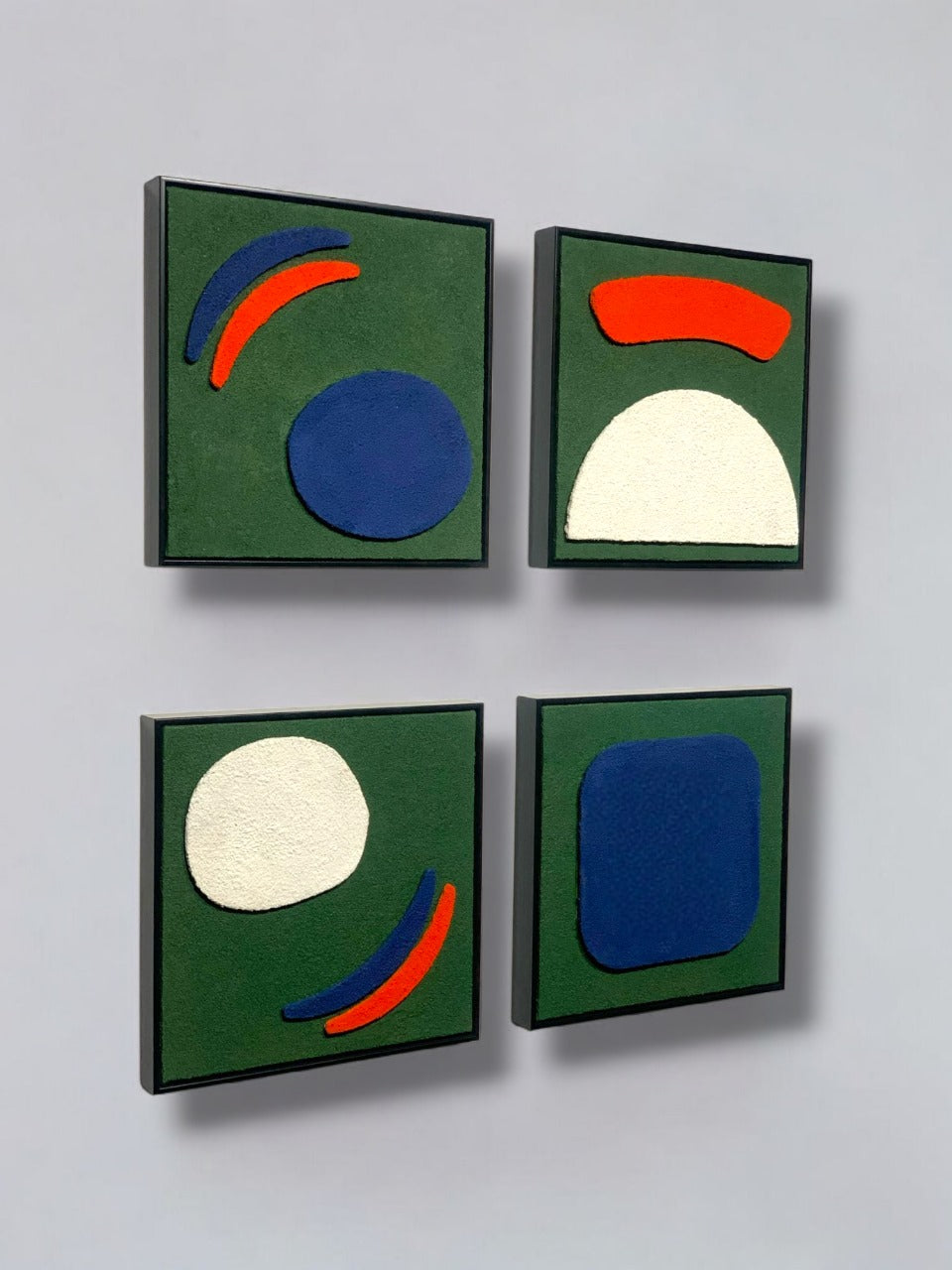 Four abstract artworks with geometric shapes on a gray background