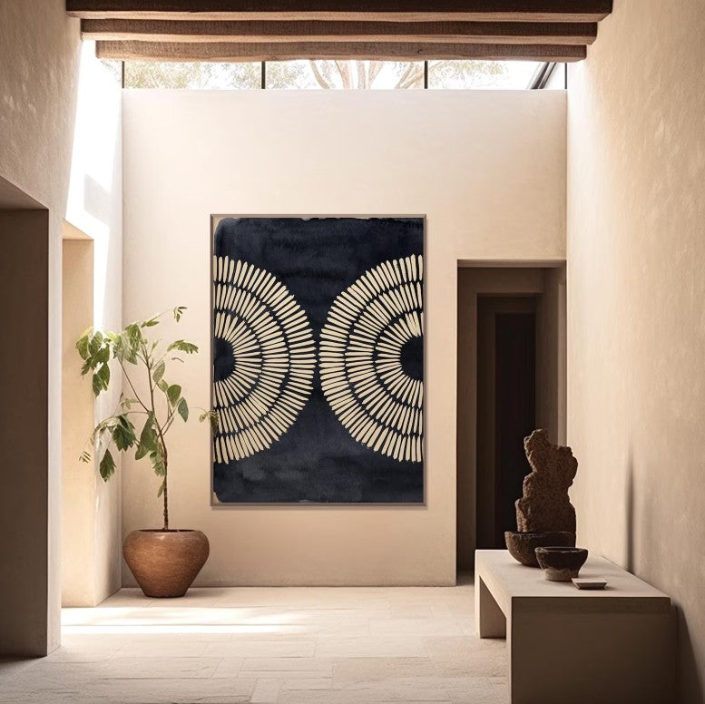 Modern interior with abstract wall art, plant, and sculptures.