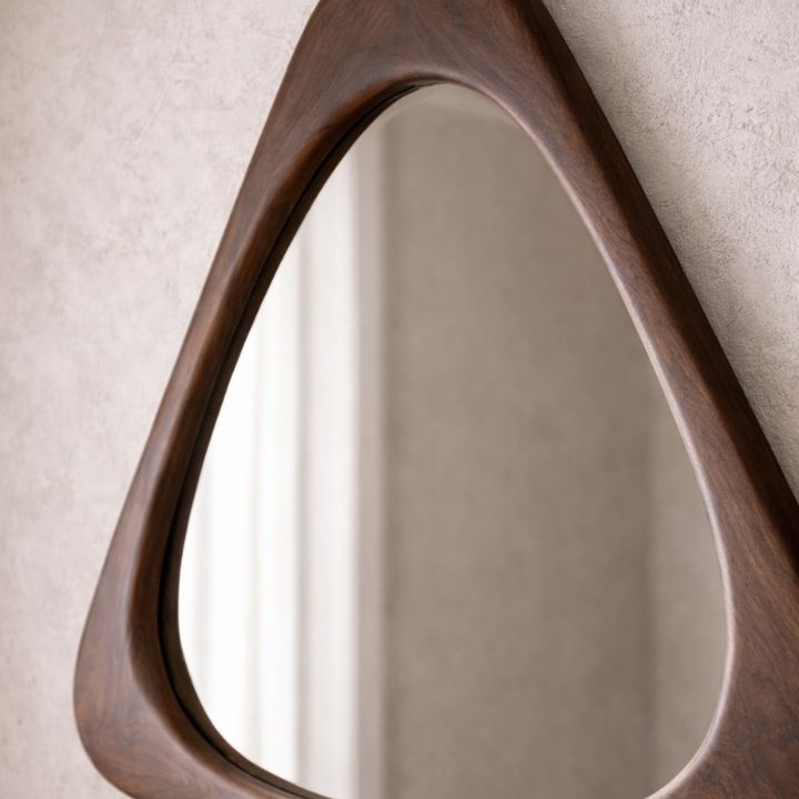 Wooden-framed mirror on a neutral wall