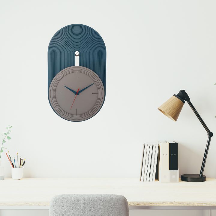 Elevate your home decor with our Modern Nordic Wall Clock, a perfect blend of minimalist design and functional elegance. Featuring a matte grey dial set against a teal blue arched panel with fine grooves, this clock adds a contemporary touch to any living room, bedroom, or office space. The sleek blue and red hands ensure precise timekeeping,deal for lovers of Scandinavian and modern aesthetics.