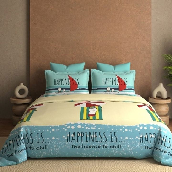 Bedding set with 'Happiness is...' design on a bed in a room.