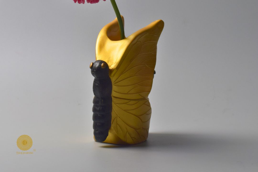 Abstract butterfly-shaped table top vase by The Gharnish, featuring artistic figurine design in a modern decorative style.