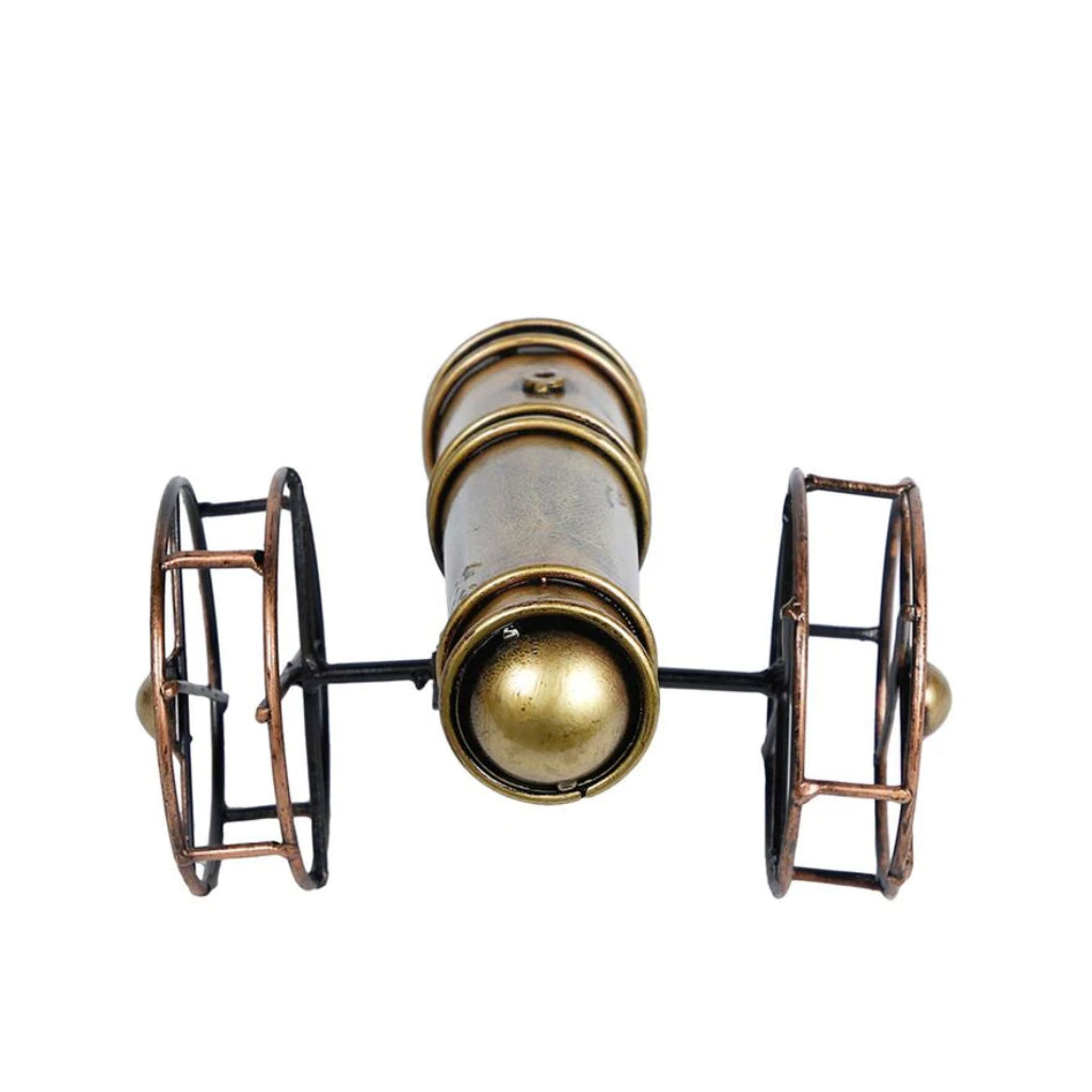 Metal cannon table decor from The Gharnish, a stylish tabletop accent with intricate metal detailing for display.
