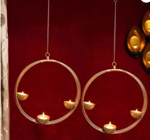 Hanging ring wire diya in an ornate urli bowl, crafted by The Gharnish, featuring a decorative metal wire design.