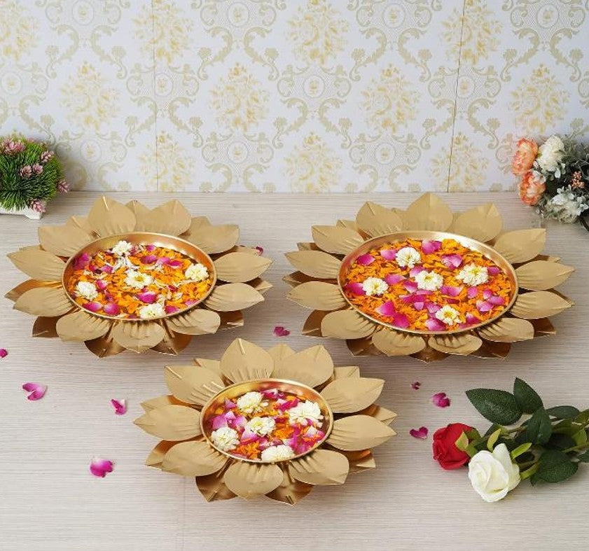 Set of four gold-finish Spread Lotus Urli bowls by The Gharnish, featuring intricate lotus designs and elegant craftsmanship.