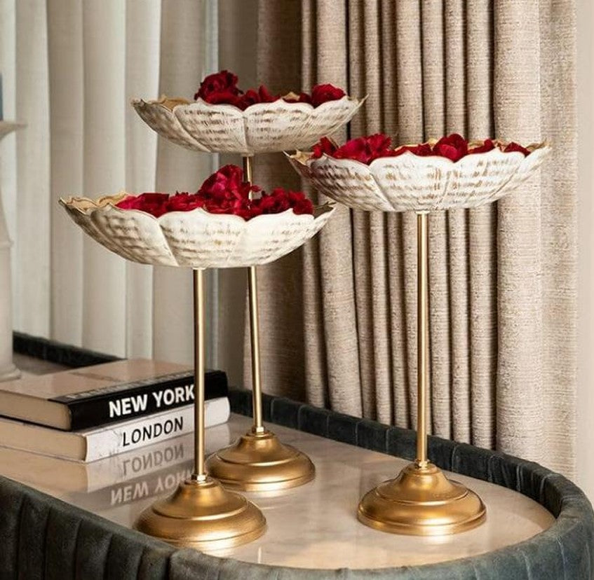 Set of three gold Lotus Urli with stands by The Gharnish, decorative metal bowls with intricate lotus designs.