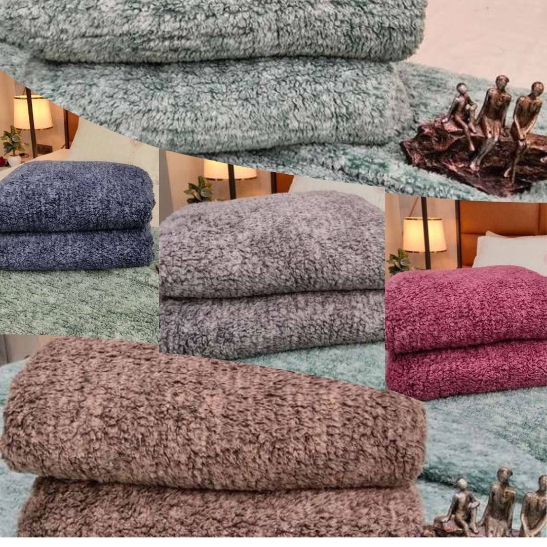 Stacks of textured towels in various colors with a blurred background.