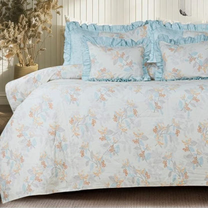 Serenity Bloom quilted 5-piece bedding set by The Gharnish with floral pattern, including bedcover, pillow shams, and sheets.