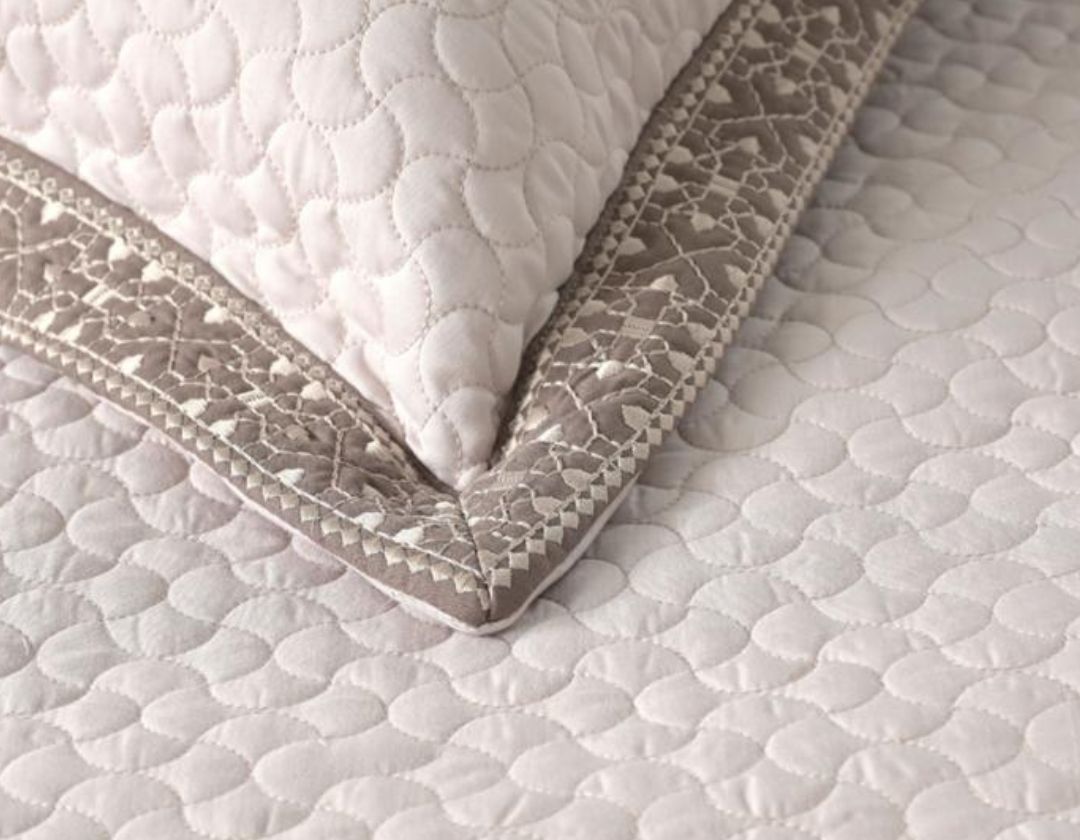 Luxury quilted embroidered bedding set with five pieces from The Gharnish, featuring intricate designs and plush fabric.