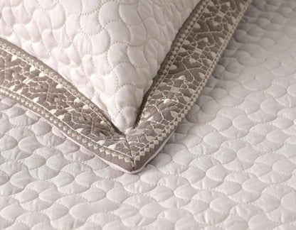 Luxury quilted embroidered bedding set with five pieces from The Gharnish, featuring intricate designs and plush fabric.