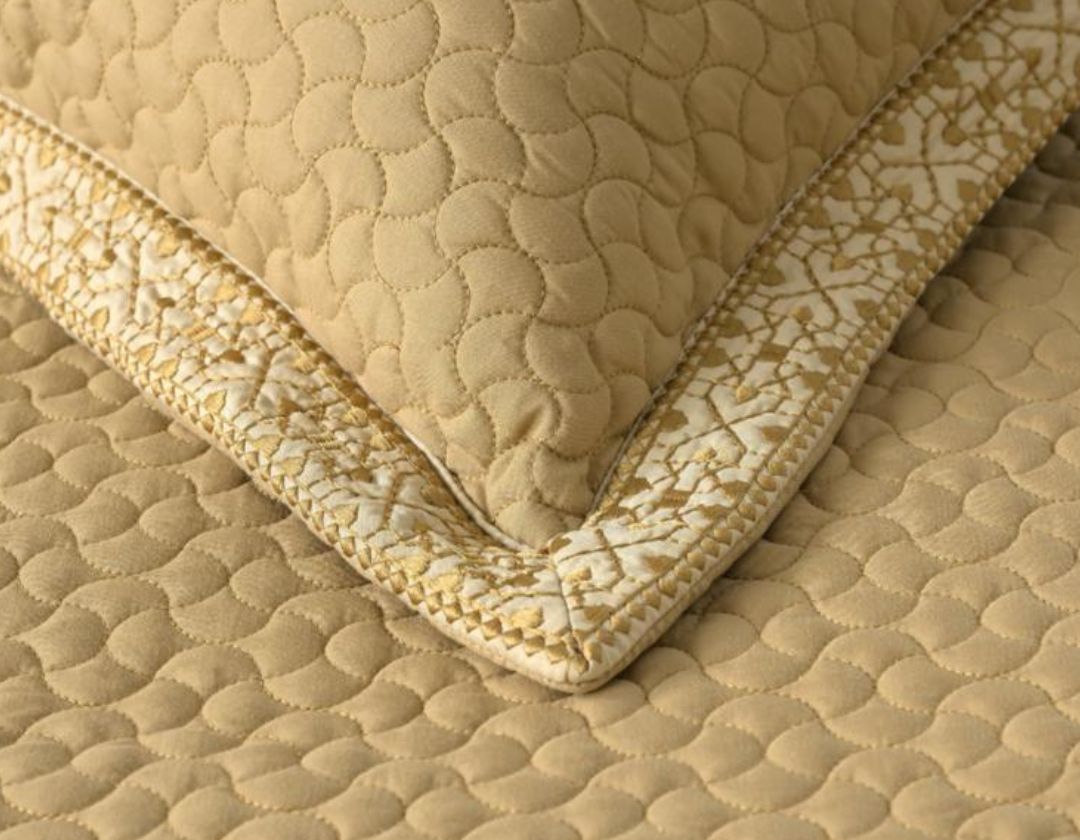 Luxury quilted embroidered bedding set with five pieces, featuring intricate embroidery and plush fabric for a elegant bedroom look.