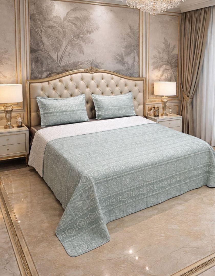 Reversible king-size quilted bedcover with lightweight jacquard pattern by The Gharnish, showcasing intricate design and soft texture.