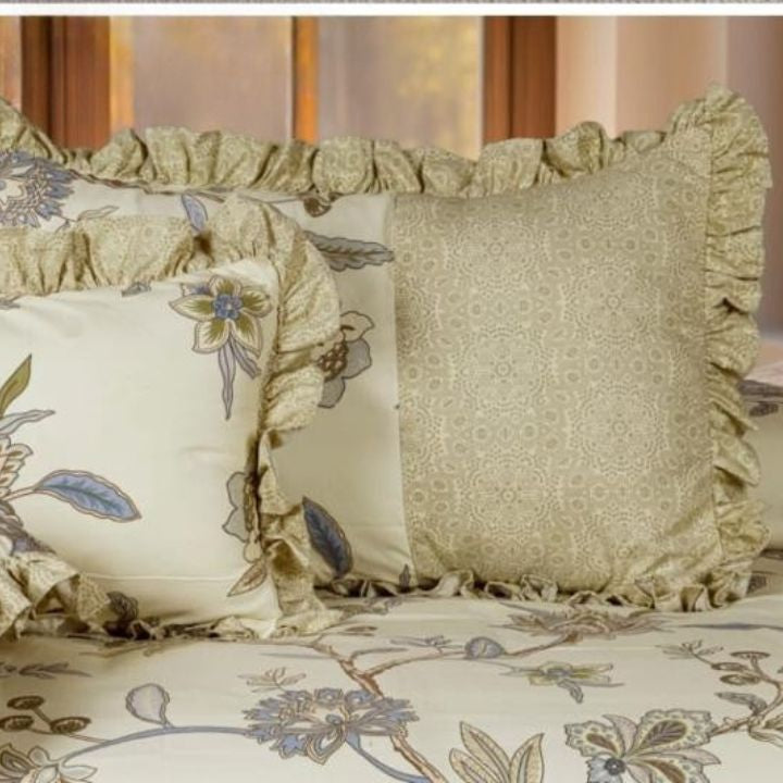 The Gharnish Serenity Bloom quilted 5-piece bedding set featuring floral patterns and matching pillowcases on a neatly made bed.