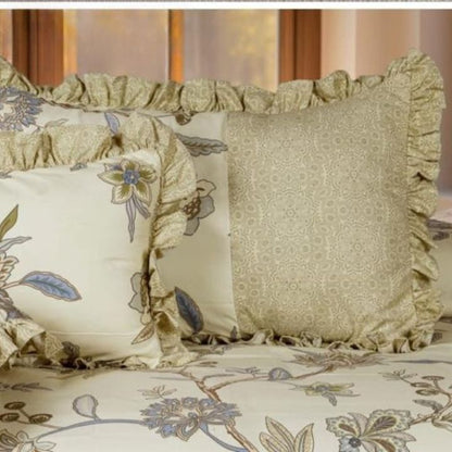 The Gharnish Serenity Bloom quilted 5-piece bedding set featuring floral patterns and matching pillowcases on a neatly made bed.