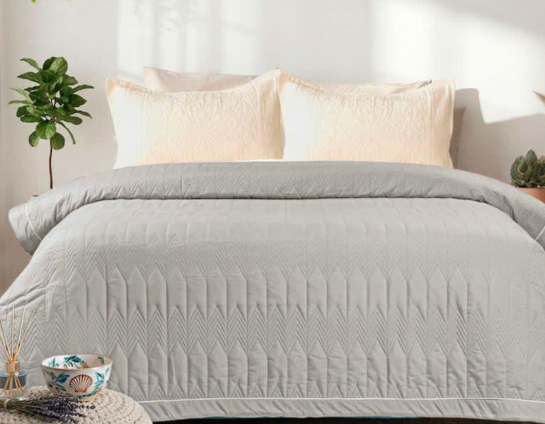 Lightweight luxury comforter from The Gharnish, all-season bedding with soft fabric and plush filling for cozy sleep.