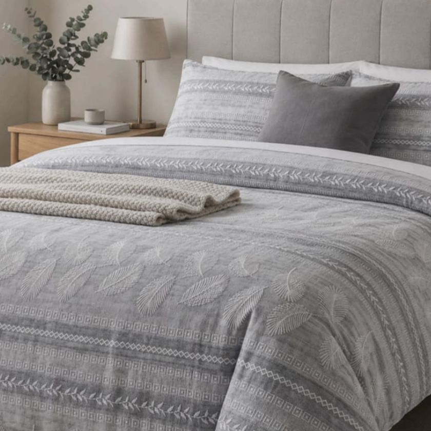 Ashwood Luxe Geometric Bedcover Set from The Gharnish, featuring stylish bedding with modern geometric patterns on a bed.