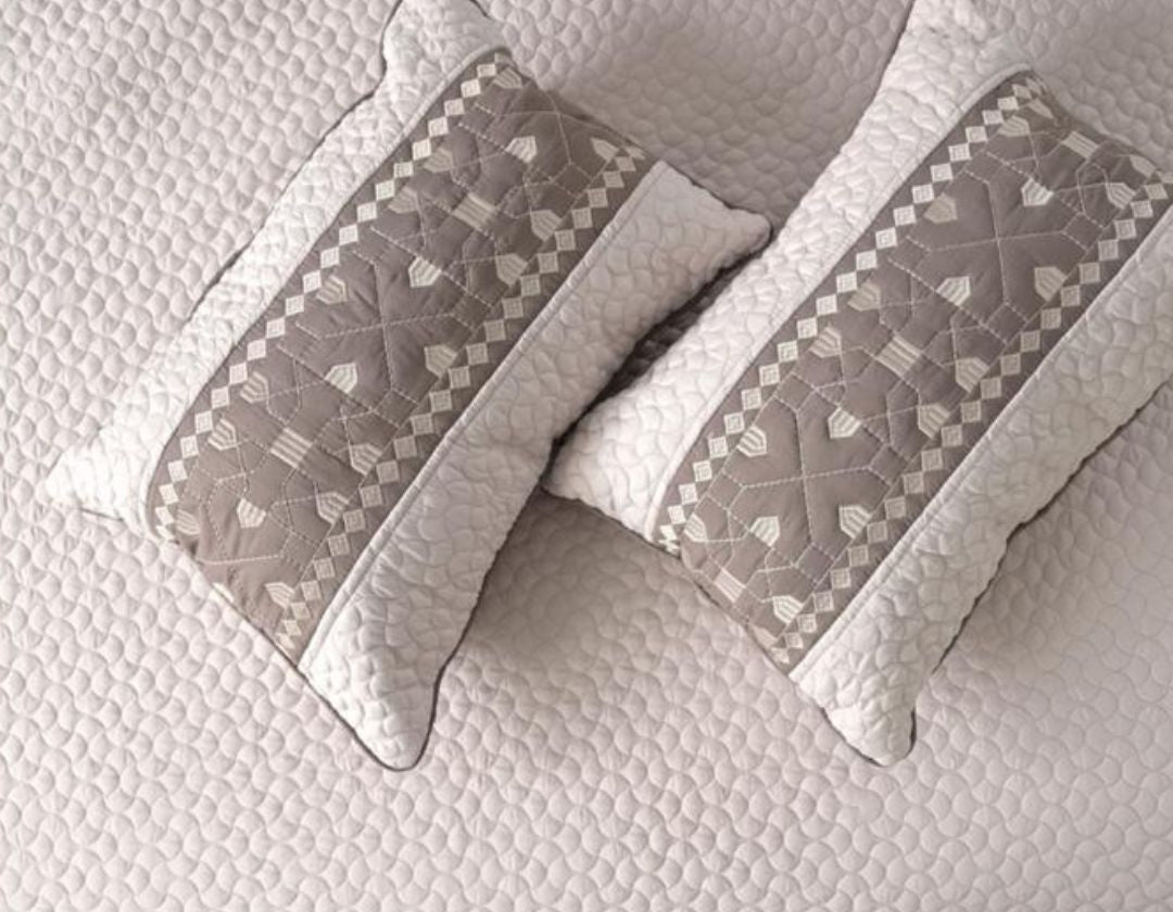 Luxury quilted embroidered bedding set by The Gharnish, 5-piece bedcover ensemble with intricate stitching and decorative patterns.