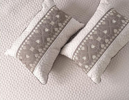 Luxury quilted embroidered bedding set by The Gharnish, 5-piece bedcover ensemble with intricate stitching and decorative patterns.