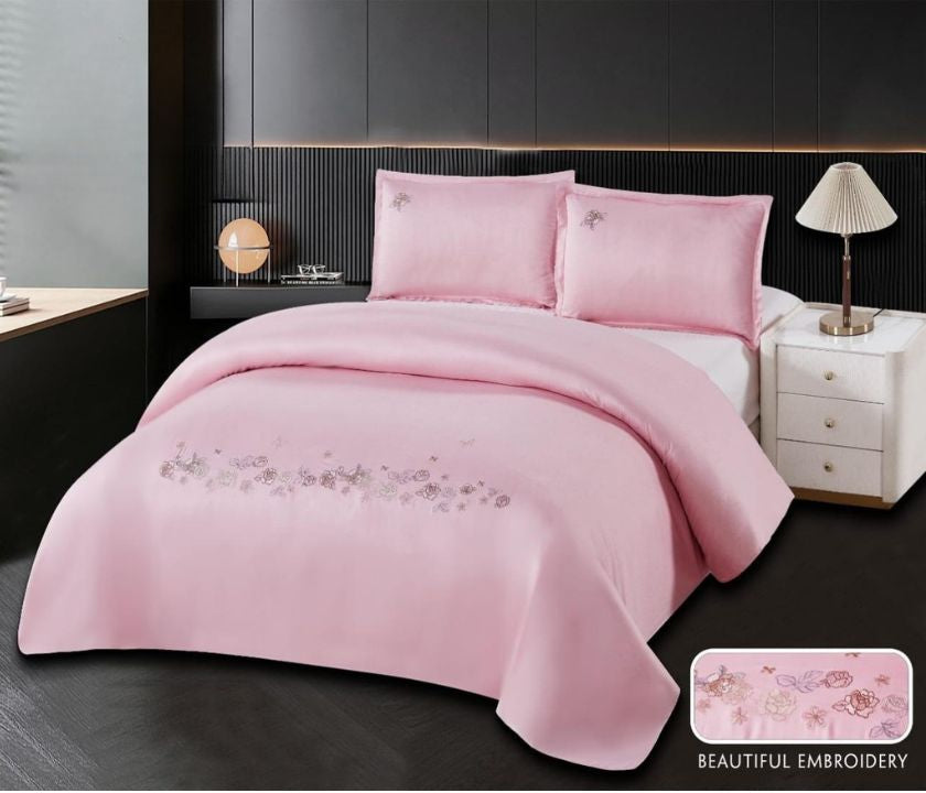 100% cotton embroidery bedding set by The Gharnish with intricate floral patterns on a soft, white bedspread.