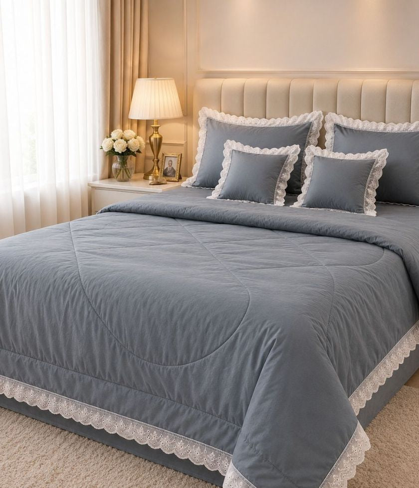 Luxury quilted king-size bedding set by The Gharnish with six matching pieces, featuring elegant quilting and plush fabric.