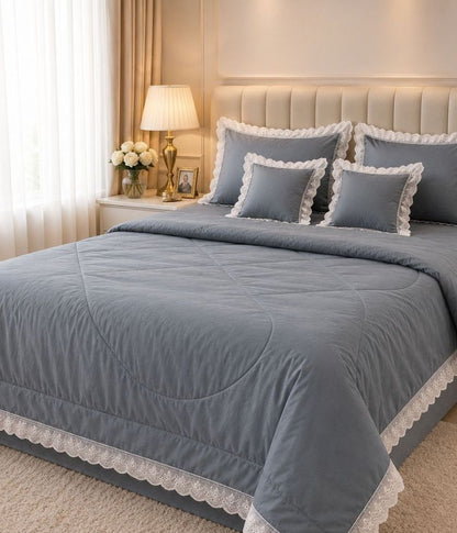 Luxury quilted king-size bedding set by The Gharnish with six matching pieces, featuring elegant quilting and plush fabric.