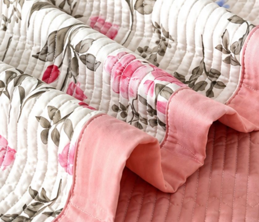 The Gharnish floral bedding set of 3 pcs with soft quilted bedcover and two matching pillow covers, featuring colorful floral patterns.