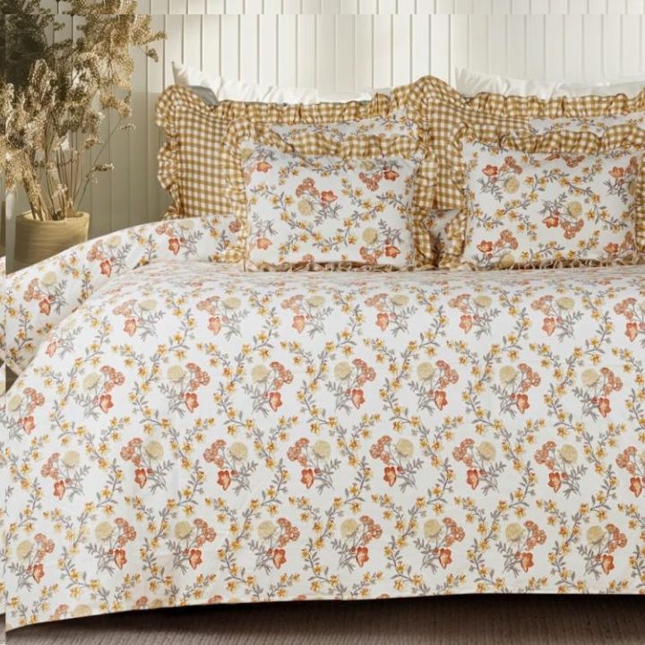 Serenity Bloom quilted 5-piece bedding set by The Gharnish featuring floral patterns and soft fabric for a cozy bedroom look.