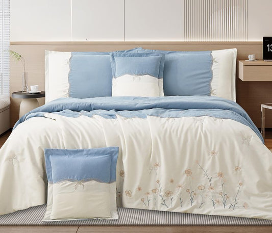 Floral embroidered bedcover set by The Gharnish featuring soft luxury bedding for modern bedrooms, with colorful floral patterns.