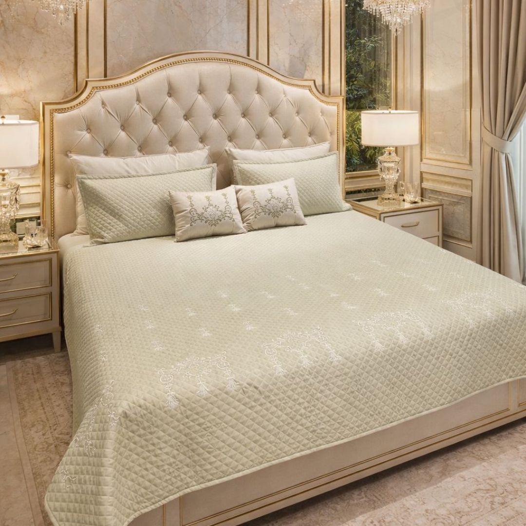 Luxurious quilted bedcover from The Gharnish, urban designer bedding with intricate quilting detail and plush texture.