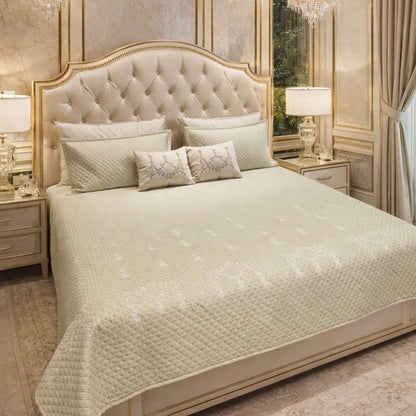 Luxurious quilted bedcover from The Gharnish, urban designer bedding with intricate quilting detail and plush texture.