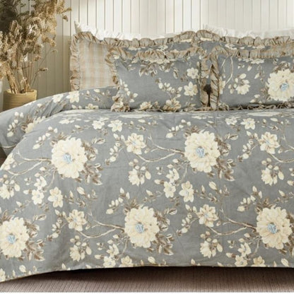 Serenity Bloom quilted bedding set by The Gharnish with five pieces, featuring floral patterns and soft fabric for a cozy bedroom look.