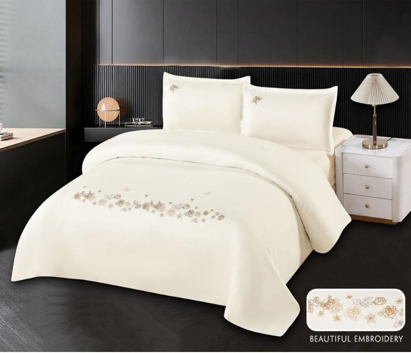 Cotton embroidery bedding set by The Gharnish featuring intricate stitched patterns on soft white fabric.