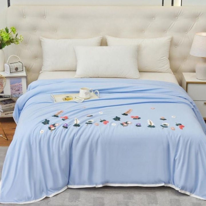 The Gharnish Florista double bed embroidery comforter with floral patterns and intricate stitching on a neatly made bed.