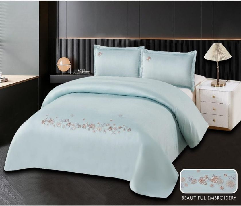 Cotton embroidery bedding set from The Gharnish, featuring intricate stitched patterns on soft, white cotton duvet cover and pillowcases.