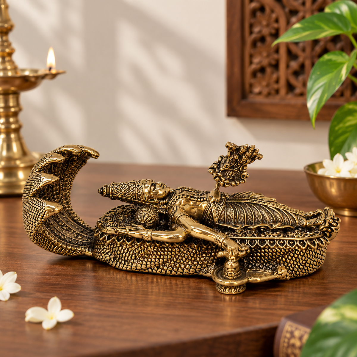 Antique brass Vishnu idol in reclining pose on Shesha, detailed craftsmanship, part of brass pooja items by The Gharnish.