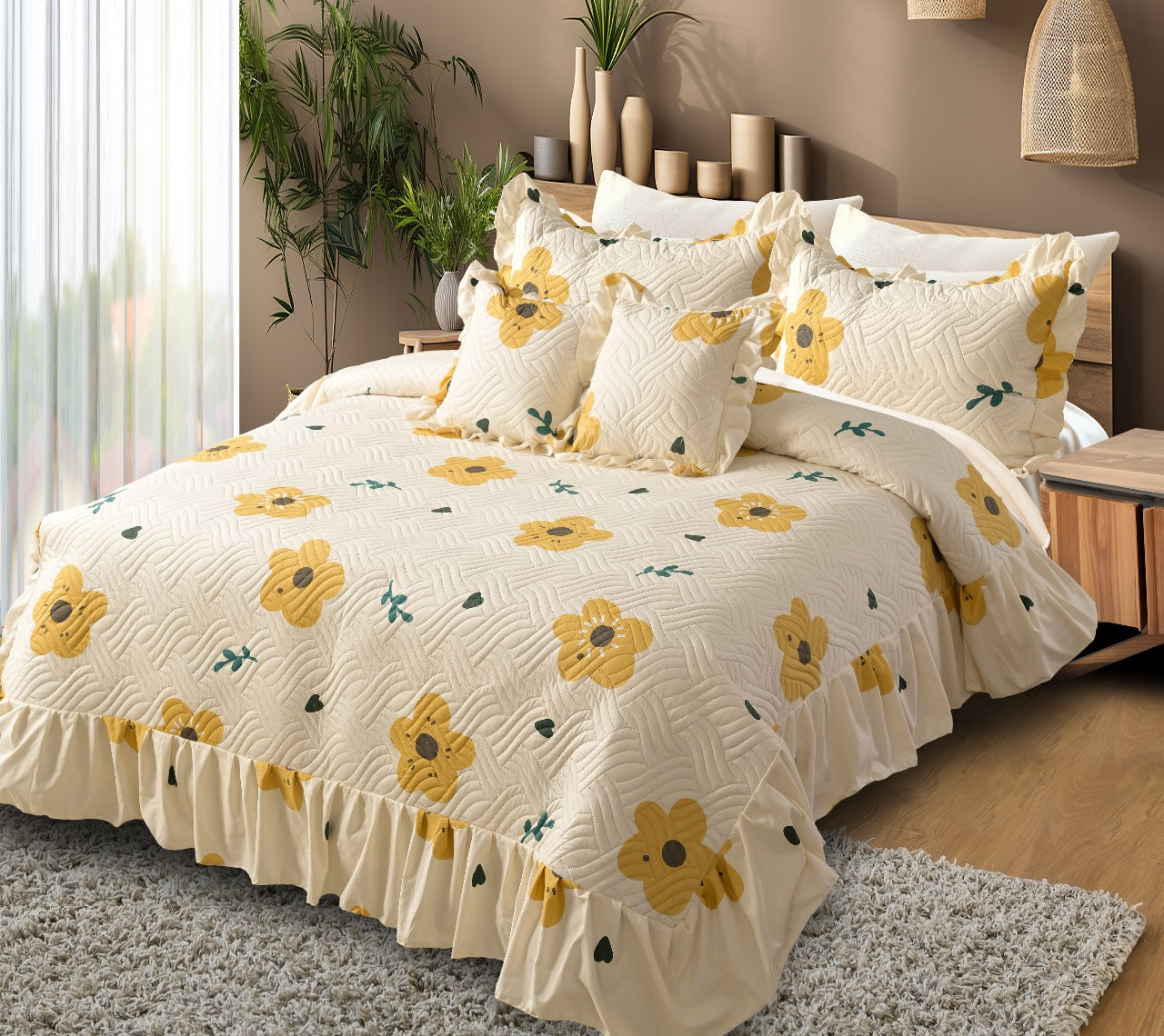 Bed with yellow floral quilt and pillows in a bedroom setting