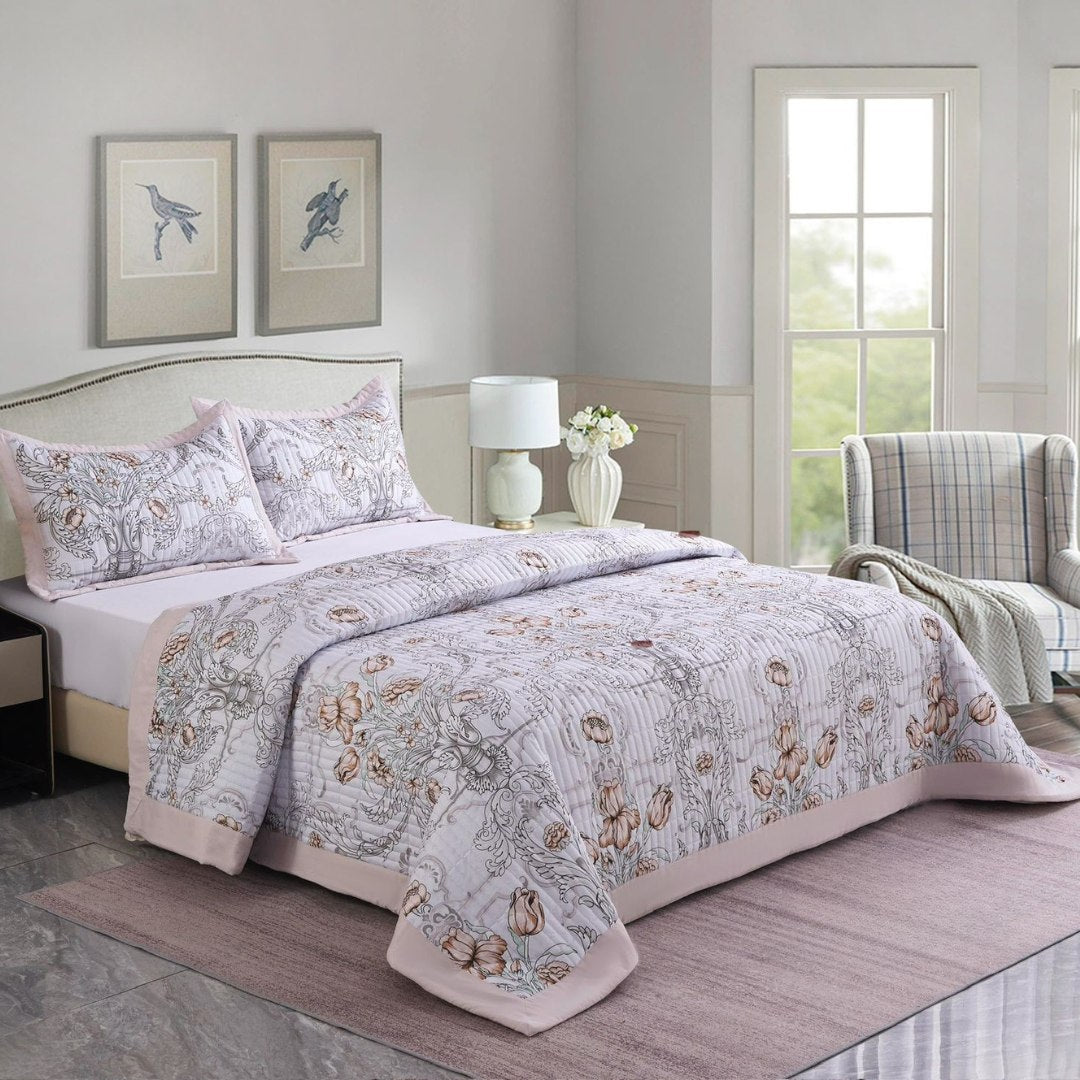Bedroom with floral comforter and pillows on a bed, lamp, and chair in the background.