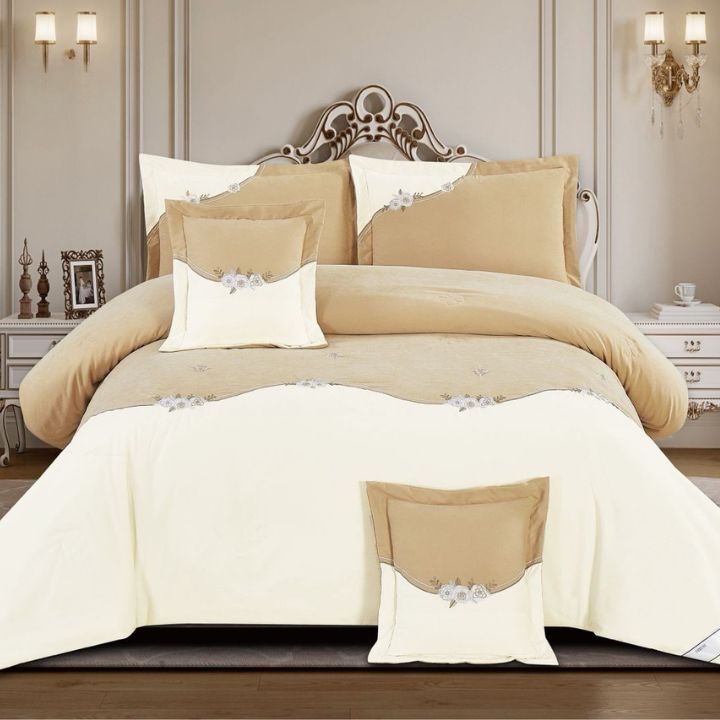 Beige and white bedding set on a bed in a bedroom setting.