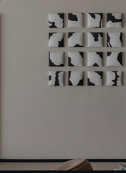 Black and white abstract wall art on a plain wall