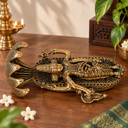 Antique brass Anantashayana Vishnu idol depicting reclining Lord Vishnu on Sheshnaag, a traditional brass pooja item.