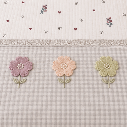 Gingham 3D floral king size quilted bedcover by The Gharnish featuring a floral pattern and quilted texture.