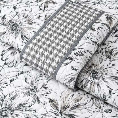 Floral bedding set of 3 with soft quilted bedcover and two matching pillow covers by The Gharnish on a bed.