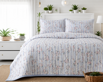 Soft floral bedding set of 3 pieces by The Gharnish with quilted bedcover and matching pillow covers on a bed.