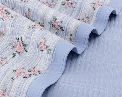 Floral bedding set of 3 pieces from The Gharnish, soft quilted bedcover with matching pillow covers on a bed.